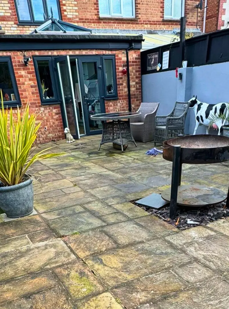 Sandstone patio with fire pit before cleaning